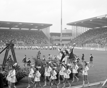 885062 Afbeelding van een praalwagen met daarop een houten slinger en 'koning voetbal' zittend op een troon, die langs ...